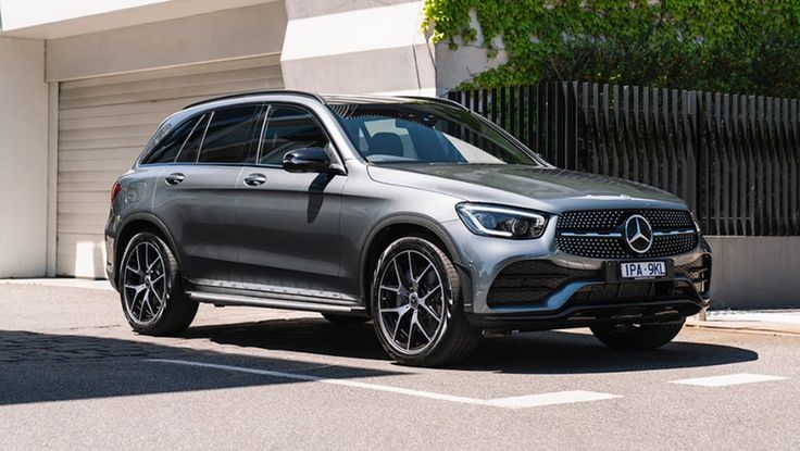 a grey mercedes benz suv parked on the street