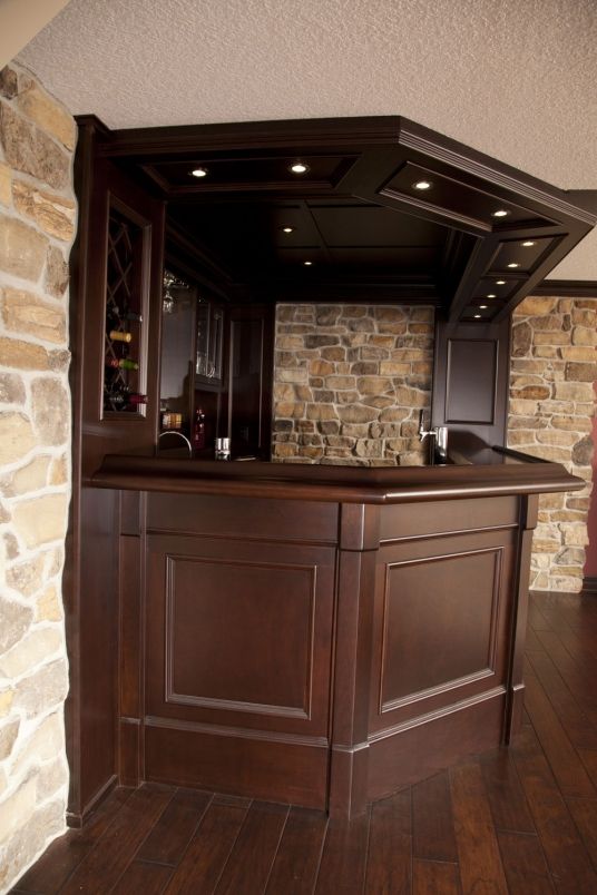 a kitchen with an island and stone wall