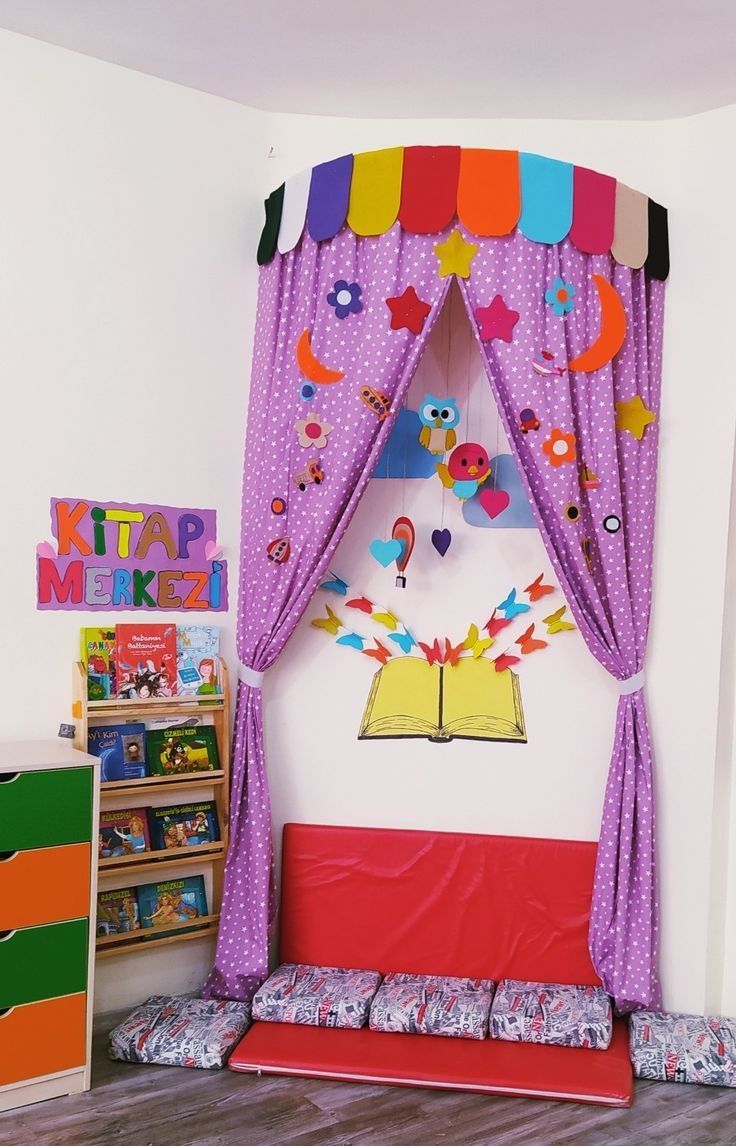 a child's bedroom decorated in pink and purple with colorful curtains on the bed