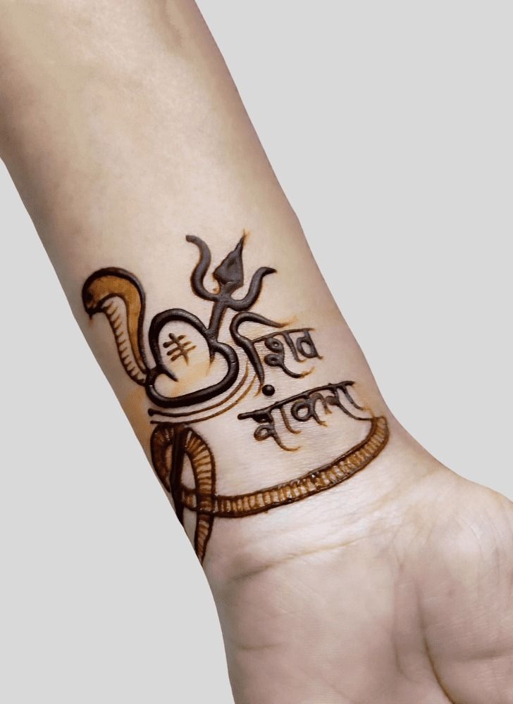 a wrist tattoo with an image of a snake and the word'bhajiya'on it