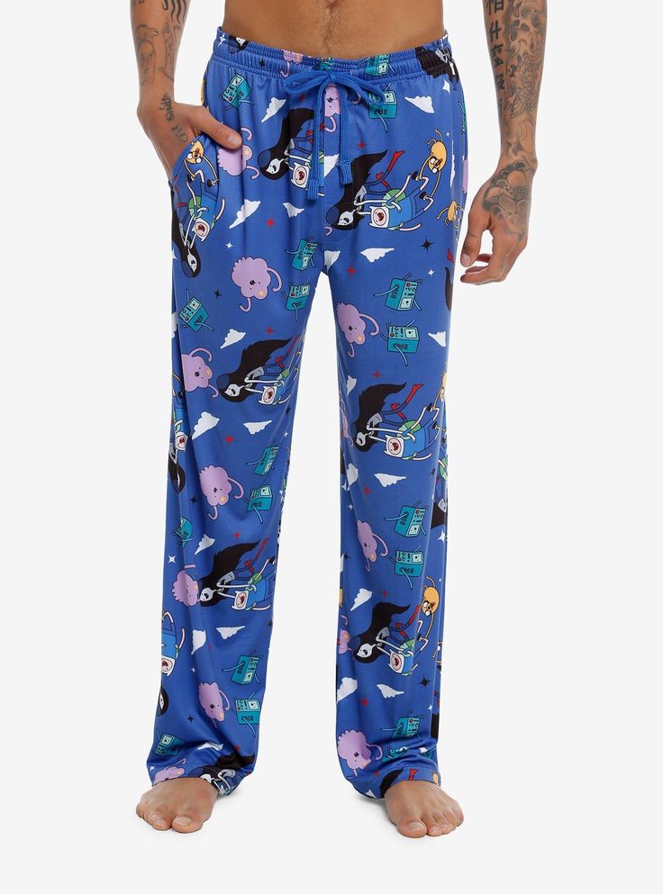 It's bedtime in the Land of Ooo. Reach for these pajama pants decorated with your fave Adventure Time characters  like Finn  Jake  BMO  Lumpy Space Princess and more. There are pockets and an elasticated  drawstring waist.92% cotton; 8% spandexWash cold; dry lowImportedListed in men'sunisex sizesModel is 6'1"Model wears size Medium Casual Cartoon Print Bottoms For Pajama Party, Playful Cartoon Print Bottoms For Sleepover, Cotton Bedtime Bottoms With Cartoon Print, Playful Blue Sleep Bottoms, Relaxed Fit Pants With Elastic Waistband For Bedtime, Playful Cartoon Print Loungewear Bottoms, Cotton Pants With Cartoon Print For Loungewear, Playful Loungewear Bottoms With Cartoon Print, Cotton Lounge Pants With Cartoon Print