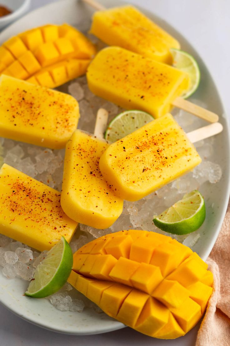 mango and lime pops on a plate with ice