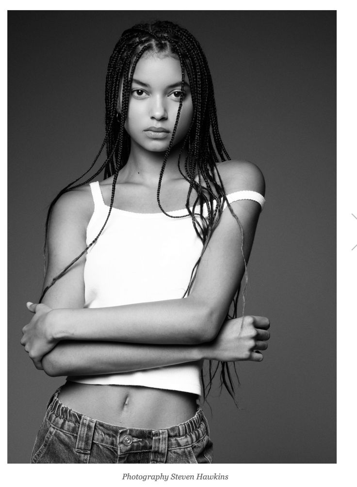 a black and white photo of a woman with dreadlocks posing for a magazine cover