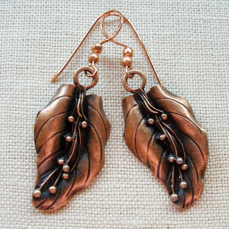 "Carefully antiqued to bring out every delicate detail, these lovely earrings offer you a sophisticated and natural look you will enjoy for day and evening wear. Metal leaves are anodized for a copper look. Hooks are copper. Drop is a generous 2 1/2\" (6 1/2cm). Boxed. (#1030). International Customers-- We are delighted to ship internationally to many locations. Please be familiar with your own country's customs duties, fees, VAT, delivery charges or taxes on the items you order, as these are yo Antique Finish Copper Drop Earrings, Antique Finish Copper Dangle Earrings, Antique Finish Copper Earrings As Gift, Nature-inspired Copper Dangle Earrings, Elegant Bronze Copper Earrings, Nickel-free Bronze Copper Earrings, Elegant Patina Earrings For Gifts, Elegant Copper Leaf Jewelry, Bronze Copper Leaf-shaped Jewelry