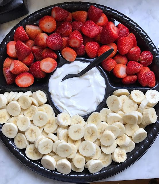 a platter filled with sliced bananas and strawberries