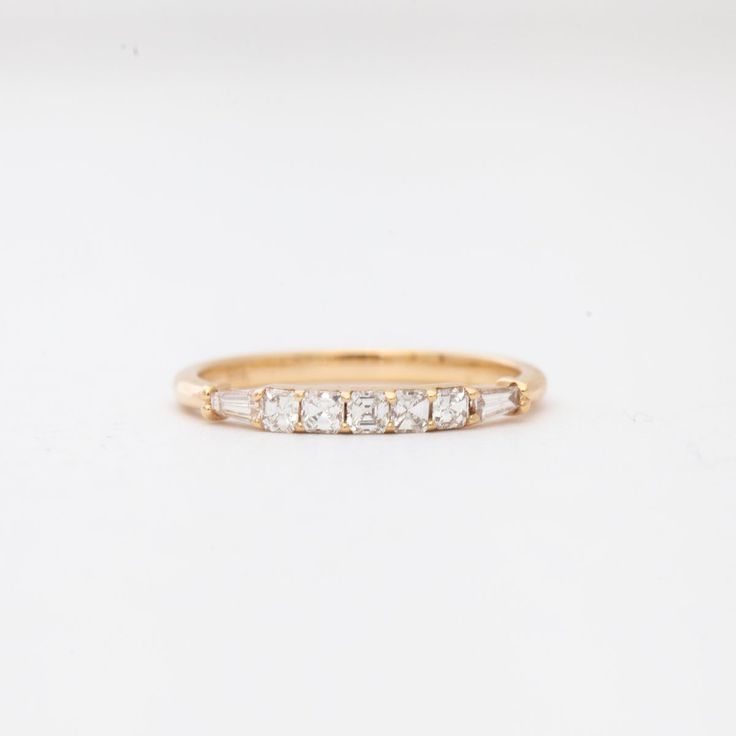 Step back in time with this new band by San Francisco-based Porter Gulch. Featuring a glittering row of asscher cut white diamonds flanked by two tapered baguettes, the Constance is an Art Deco lover's dream. Pair it with an engagement ring or add it to any ring stack that needs a touch of sparkle. Made in San Francisco. All sizes made to order within 4-6 weeks. To inquire about different metals, sizes, or custom center stones, contact us. 14 karat gold with five asscher cut white diamonds and t Notes In Music, Ring Stack, Asscher Cut, New Bands, Step Back, Baguette Diamond, Back In Time, White Diamonds, Diamond White