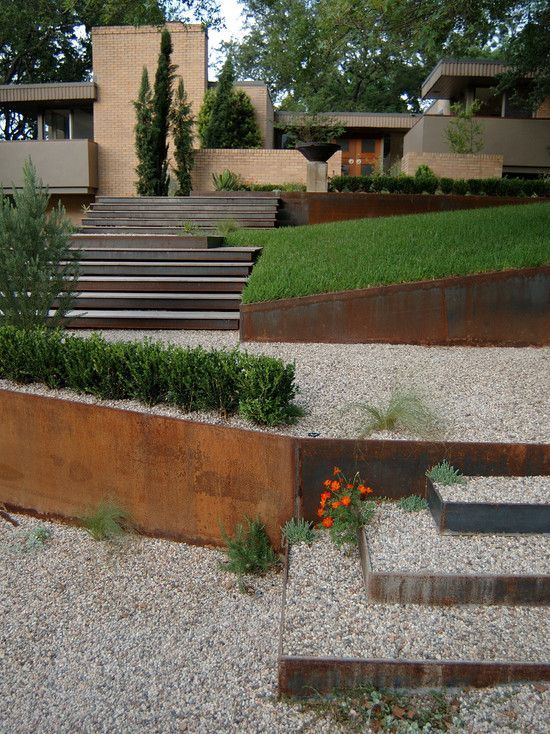 an outdoor garden with metal steps and plants