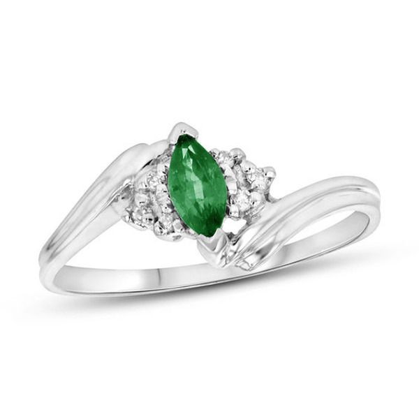 A marvelous choice for day or night, this charming gemstone and diamond ring makes creating a chic look easy. Crafted in 14K white gold, this graceful style features a rich 6.0 x 3.0mm marquise-cut verdant-green emerald. Trios of sparkling diamonds flank the center stone while the sculpted double ribbons of the shank bypass around the center. Radiant with 1/20 ct. t.w. of diamonds and a brilliant buffed luster, this ring gleams with exquisite design. Marquise Emerald Ring In White Gold For Formal Occasions, Fine Jewelry Emerald Ring In White Gold With Diamond, Formal Marquise Emerald Ring In White Gold, White Gold Emerald Ring With Center Stone, Formal White Gold Marquise Emerald Ring, Classic Diamond Ring With Accent Stones For May Birthstone, Fine Jewelry Marquise Emerald Promise Ring, Emerald Ring In 14k White Gold With Brilliant Cut, Formal May Birthstone Diamond Ring With Center Stone