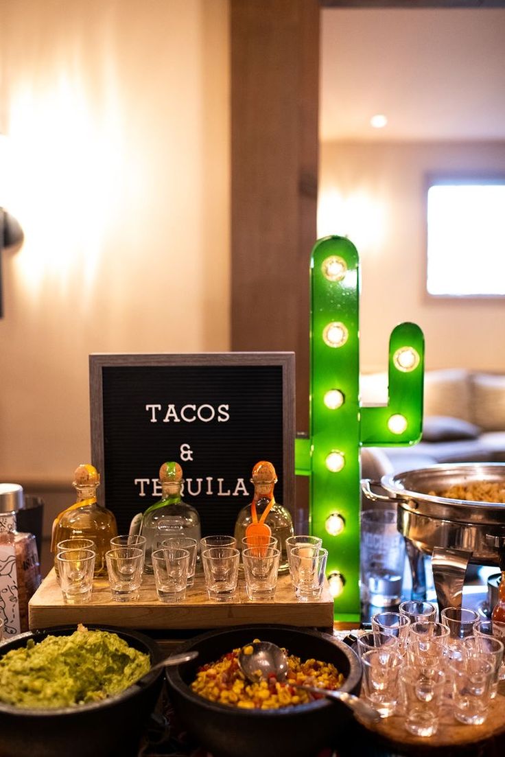 a table topped with lots of different types of food and glasses on top of it