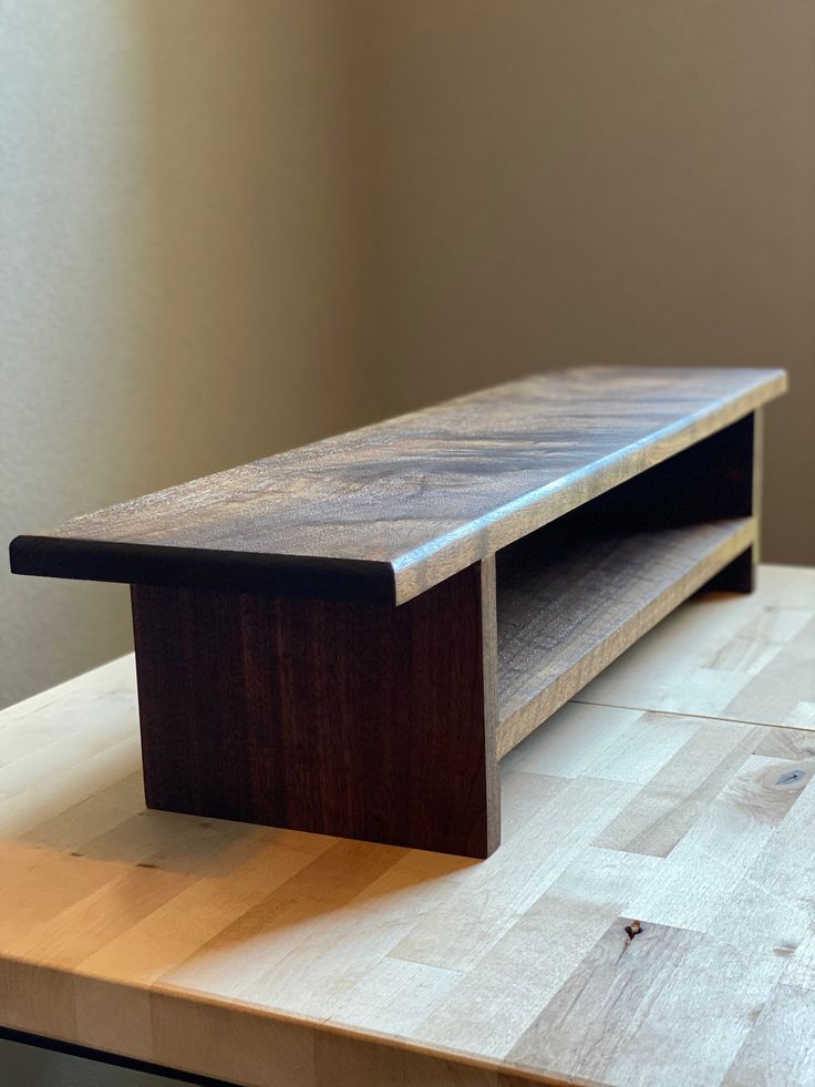 a wooden shelf sitting on top of a table