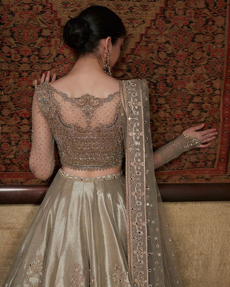 the back of a woman's dress in gold