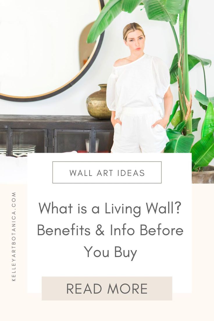 a woman standing in front of a mirror with the words what is a living wall? benefits and info before you buy