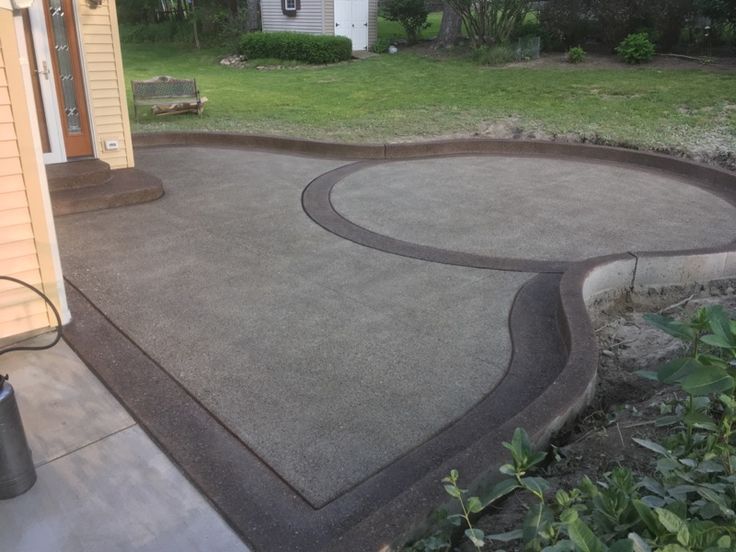 a concrete patio in front of a house