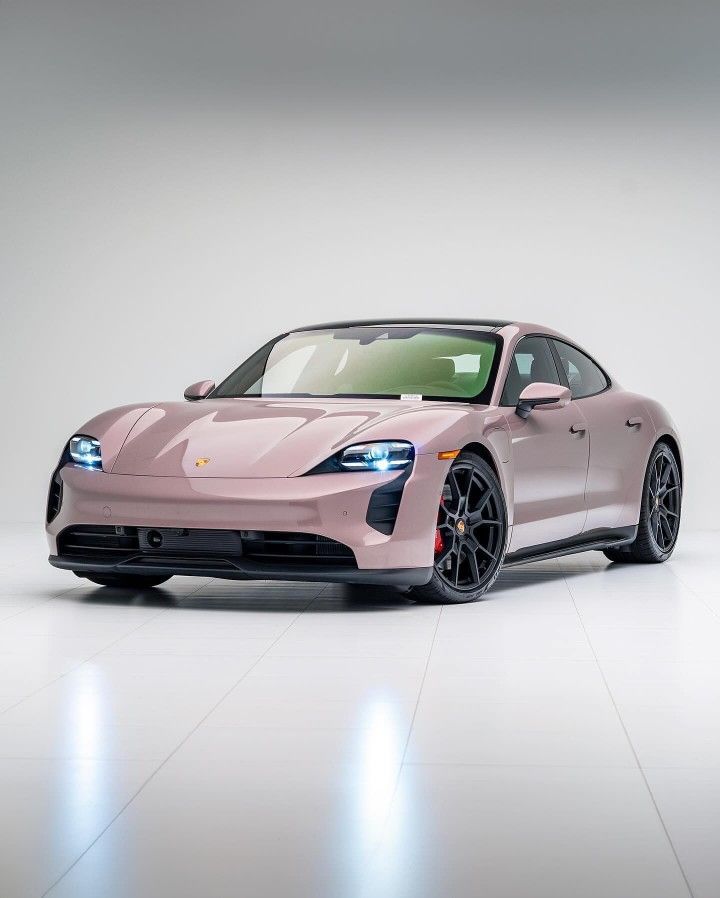 a pink sports car parked in a white room