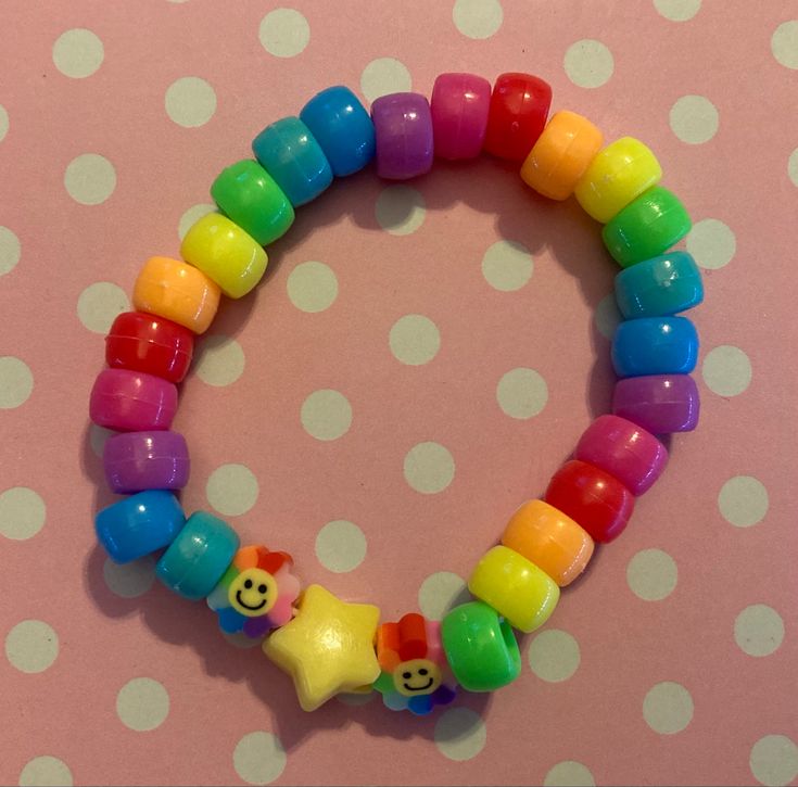 there is a bracelet made out of plastic beads with a star on the bead