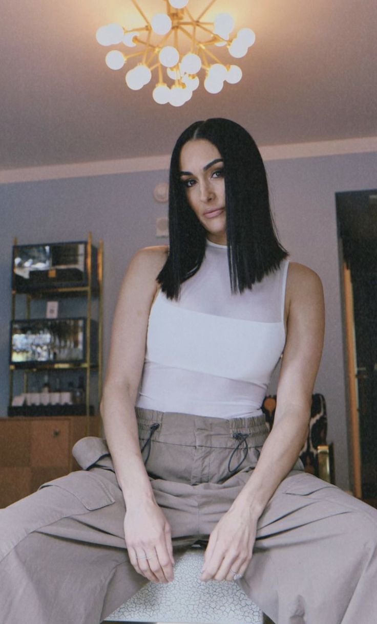 a woman sitting on top of a chair in a room