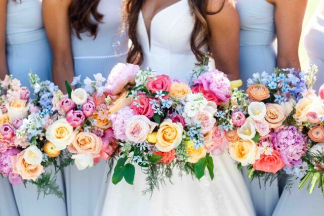 a group of bridesmaids holding bouquets of flowers