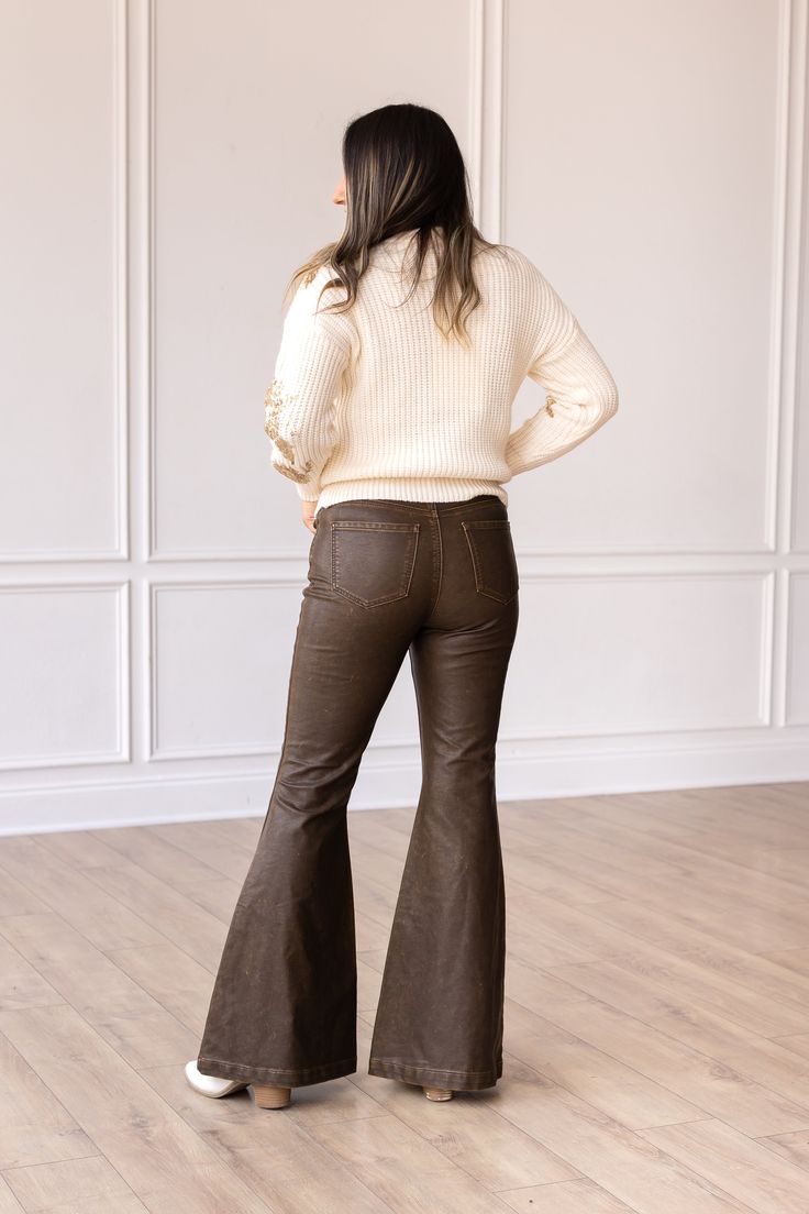 These bellbottoms are not just pants; they are a statement piece. Pair them with a flowy blouse, a tucked-in tee, or a tailored blazer – the styling possibilities are endless.Model & Fit Model: Maggie ( 5'5 and Size 6 or S) Fitted through waist and hips Stretch: No Zipper Fly Light distressing throughout for a more worn look Flare Leg High rise: 11.5" Inseam: 32" Fabric & Care Material: 100% PU Leather Care Instructions: Wash Cold, Dry Flat Manufactured overseas Wide Leg Brown Flare Jeans For Work, Chic Brown Wide Leg Flare Jeans, Chic Wide-leg Flare Jeans For Winter, Chic Wide Leg Flare Jeans For Winter, Trendy Brown Flare Jeans For Fall, 70s Inspired Wide Leg Pants For Fall, 70s Inspired Wide Leg Flare Jeans For Fall, 70s Inspired Fall Flare Jeans, Trendy Fall Flare Jeans With Flared Hem