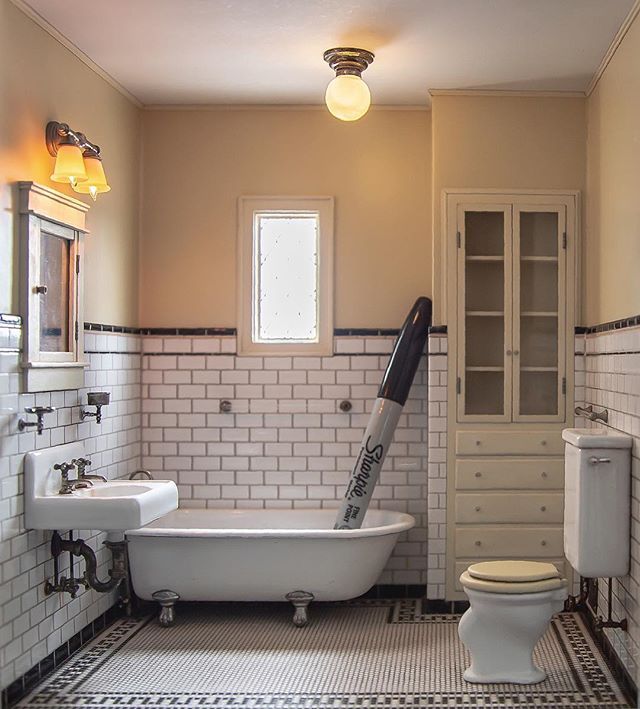 a bathroom with a claw foot tub, toilet and sink