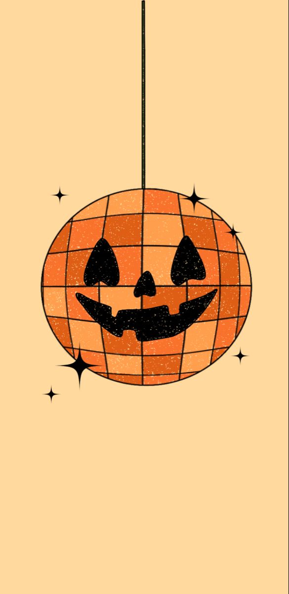 an orange and black pumpkin lantern hanging from a wire with stars on it's sides