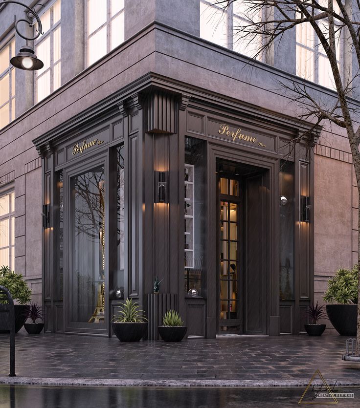 an elegant building with potted plants on the outside