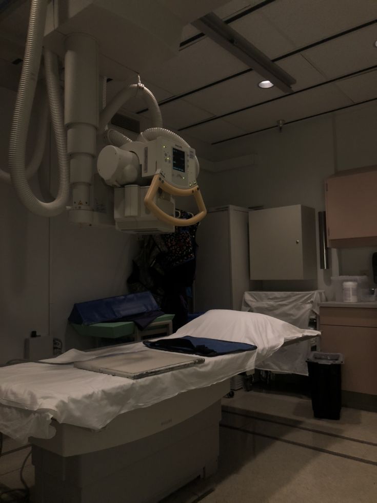 an empty hospital room with medical equipment in it