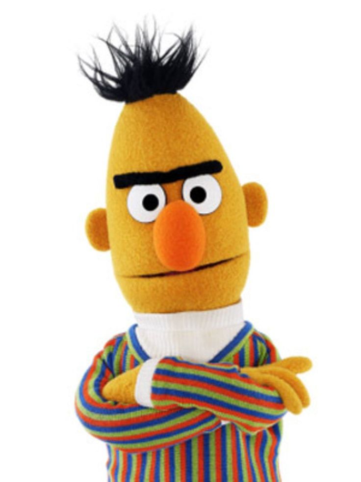 the sesame character is wearing a striped shirt and standing with his arms folded up in front of him