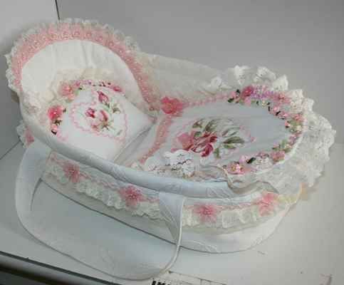 a white basket sitting on top of a table next to a pillow and other items