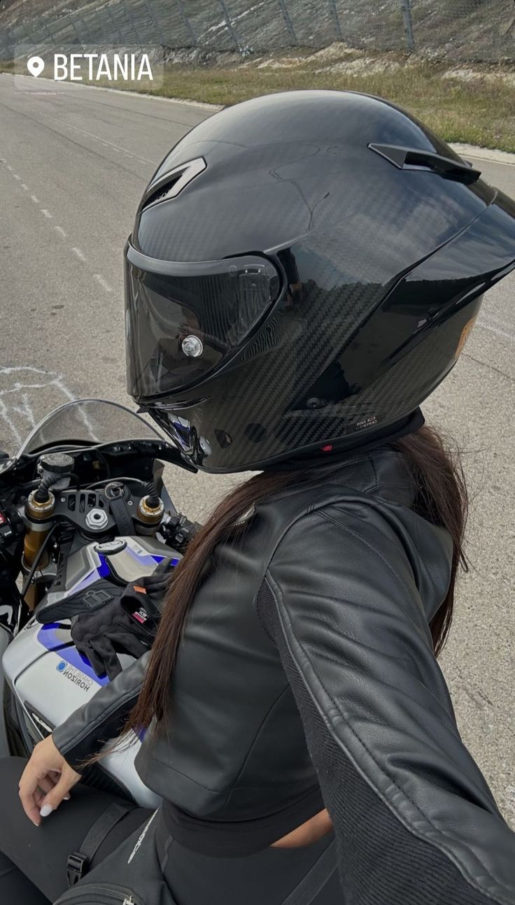 a person wearing a helmet and riding a motorcycle