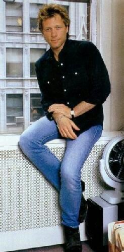 a man sitting on top of a window sill next to an air conditioner