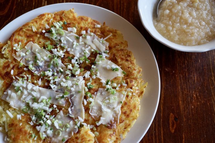 a white plate topped with food next to a bowl of oatmeal