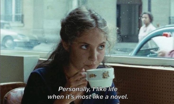 a woman sitting at a table with a cup in her hand and the caption says, personal, like life when it's most like a novel