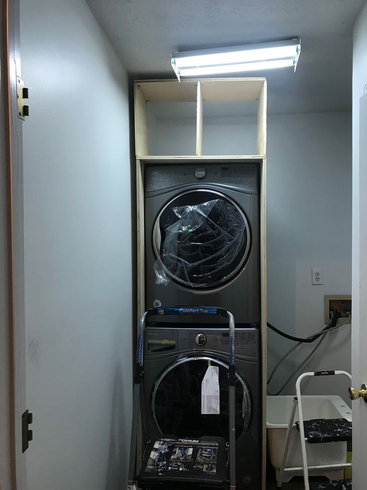 a washer and dryer in a room with no doors on the door,