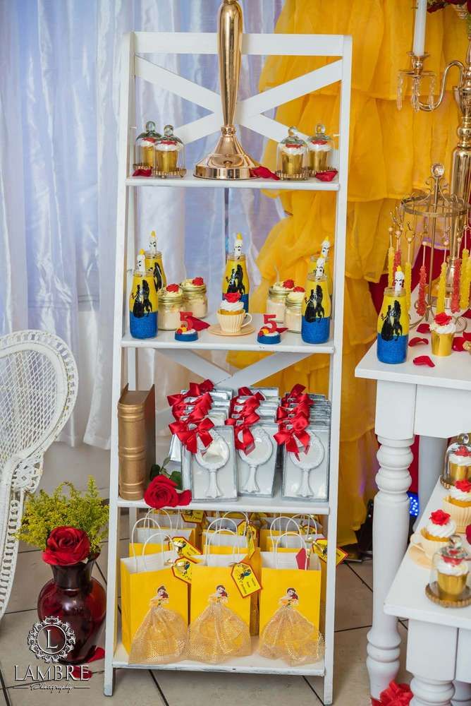 a white shelf filled with cakes and cupcakes