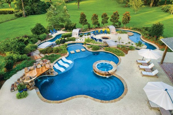 an aerial view of a swimming pool with lounge chairs and umbrellas