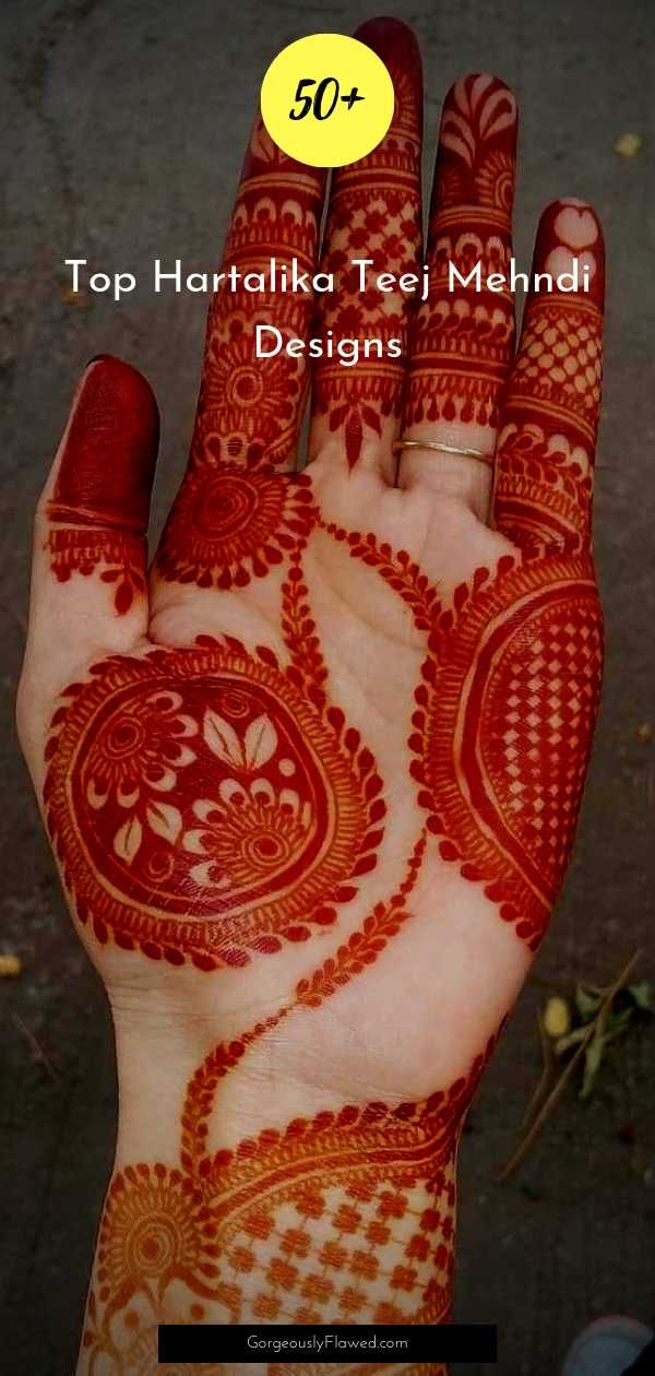 the hand is decorated with henna designs