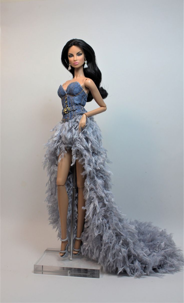 a barbie doll wearing a blue dress and feathered skirt