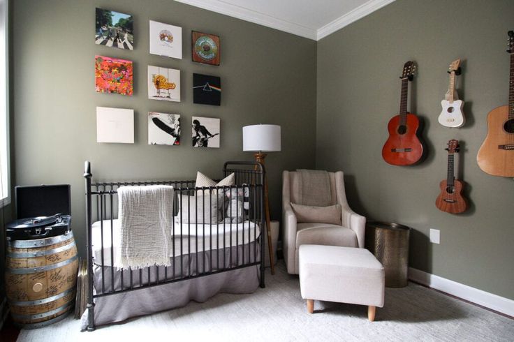 a baby's room with guitars on the wall