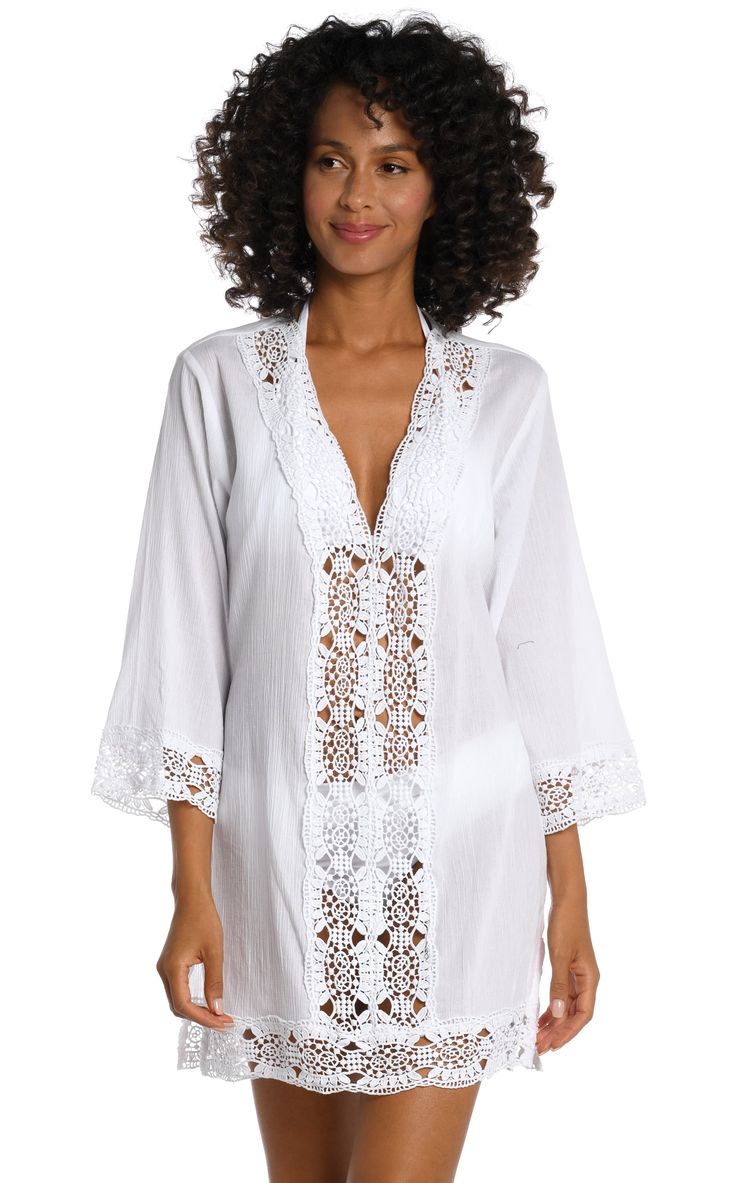 Sweetly sophisticated, this solid tunic offers just the right amount of coverage with a crocheted center panel in front to offer a glimpse of your swimsuit underneath. Crocheted trim around the neck, cuffs and hem gives this post-dip cover-up an effortless elegance that takes you from beach to brunch in style. [split] Details V-neck tunic 3/4-length sleeves Crocheted trim Lightweight fabric Breezy silhouette Fabric Summer Split Neck Top For Beach, Chic Split Neck Tops For The Beach, Beachwear Tops With Crochet Trim For Beach Cover-up, Elegant Long Sleeve Swimwear For The Beach, Beach Tops With Crochet Trim For Beachwear, Beachwear Tops With Crochet Trim For Beach, Stretch Swimwear With Crochet Trim, Crochet Trim Tops For Beachwear, Casual Lace Trim Cover-up