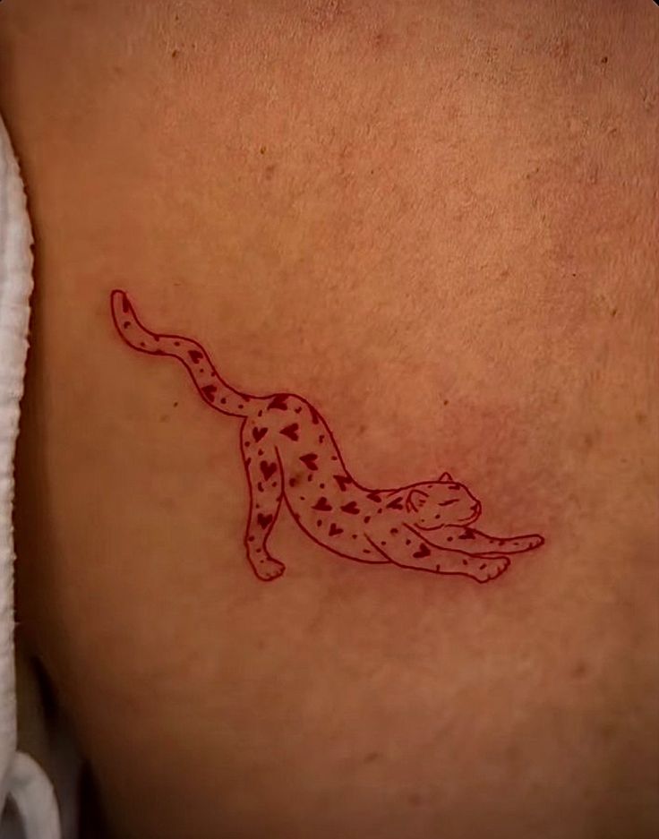 a tattoo on the back of a woman's stomach that has an image of a cheetah