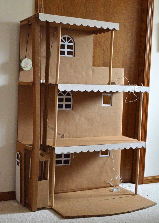 a cardboard doll house is sitting on the floor