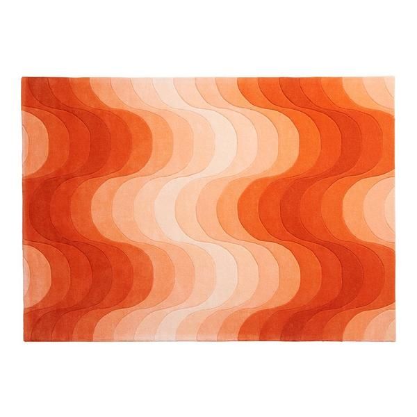 an orange and white rug with wavy waves on it's surface, in the shape of a wave