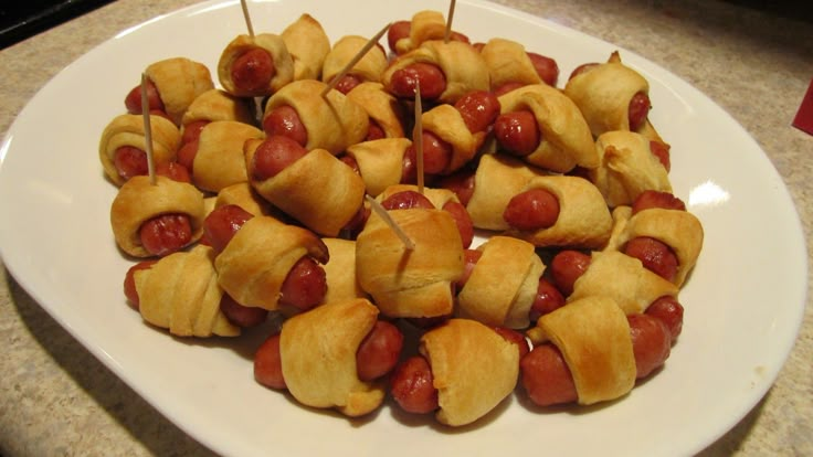 a white plate topped with pigs in a blanket