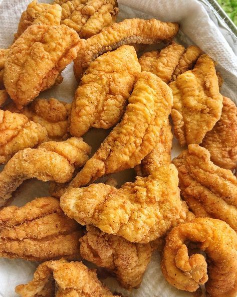 some fried food is sitting on a white paper towel with lettuce in the background