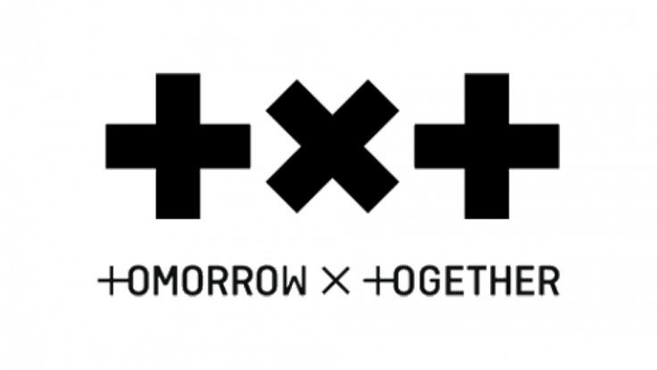 the logo for tomorrow x together, which is black and white with two crosses on it