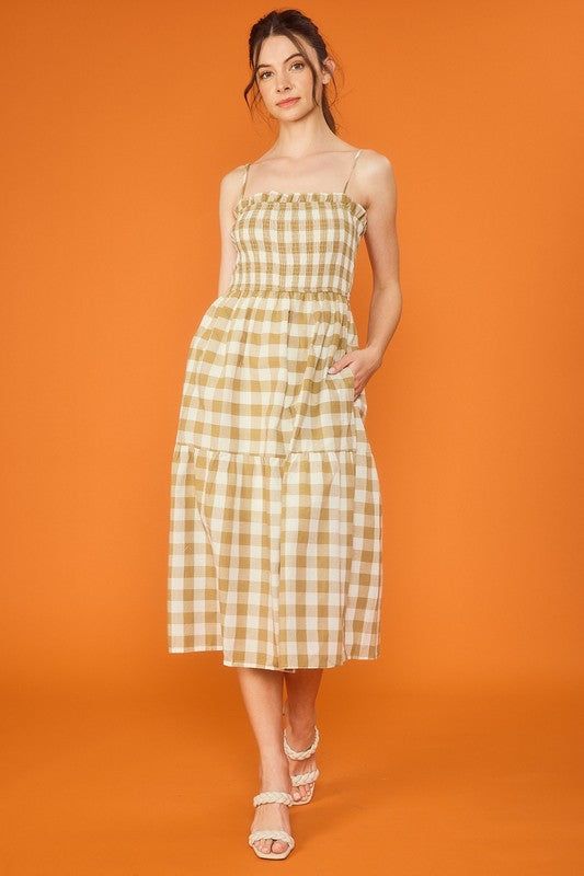 Look cute and comfortable in our Smocked Top Checker Dress! Made with 100% cotton, it features a tiered design, side pockets, and skirt lining for added style and practicality. Perfect for any day out (or staying in with pockets!). Casual Cotton Dresses With Pockets, Chic Cotton Smocked Dress With Ruffle Hem, Spring Sundress With Pockets For Summer, Summer Sundress With Pockets For Spring, Sleeveless Cotton Sundress With Pockets, Summer Cotton Sundress With Smocked Back, Spring Cotton Smocked Dress With Ruffles, Summer Cotton Dress With Pockets, Spring Sundress With Smocked Bodice And Tiered Skirt