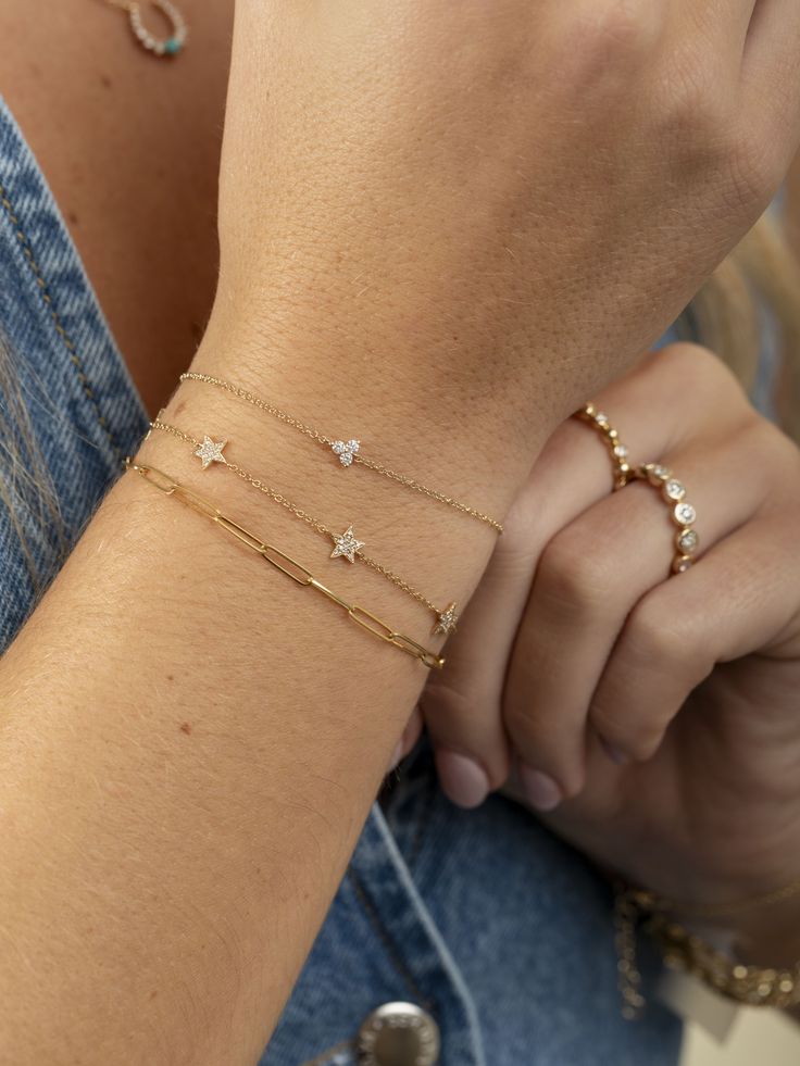 LeMel is known for its dainty gold jewelry! This dainty diamond star bracelet is the perfect addition to any bracelet stack! Layer it with a paperclip chain bracelet or make a statement with some tennis jewelry! Bracelet Stack Tennis Bracelet, Luxury Minimalist Diamond Chain Bracelet, Bracelet Stack Dainty, Dainty Star-shaped Bracelets For Everyday Wear, Elegant Everyday Bracelets With Star Charm, 14k Gold Dainty Bracelet With Star Charm, Gift Diamond Bracelet With Paperclip Chain, Dainty 14k Gold Bracelet With Star Charm, Diamond Paperclip Chain Bracelet