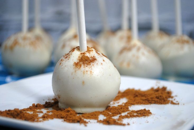 there are several desserts on the plate with sticks sticking out of them and sprinkled with cinnamon