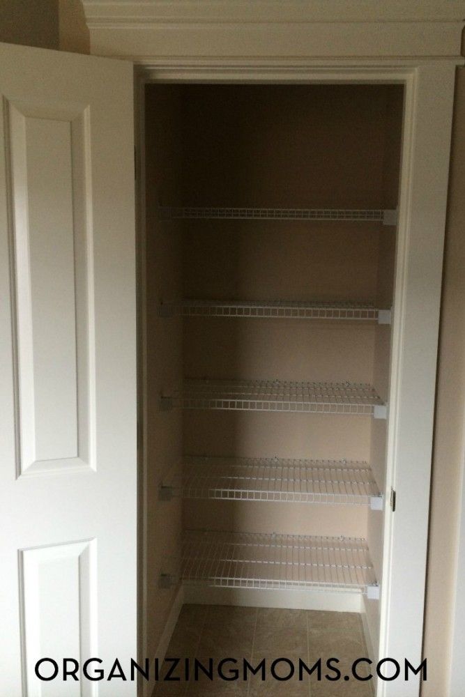 an empty closet with shelves and doors open