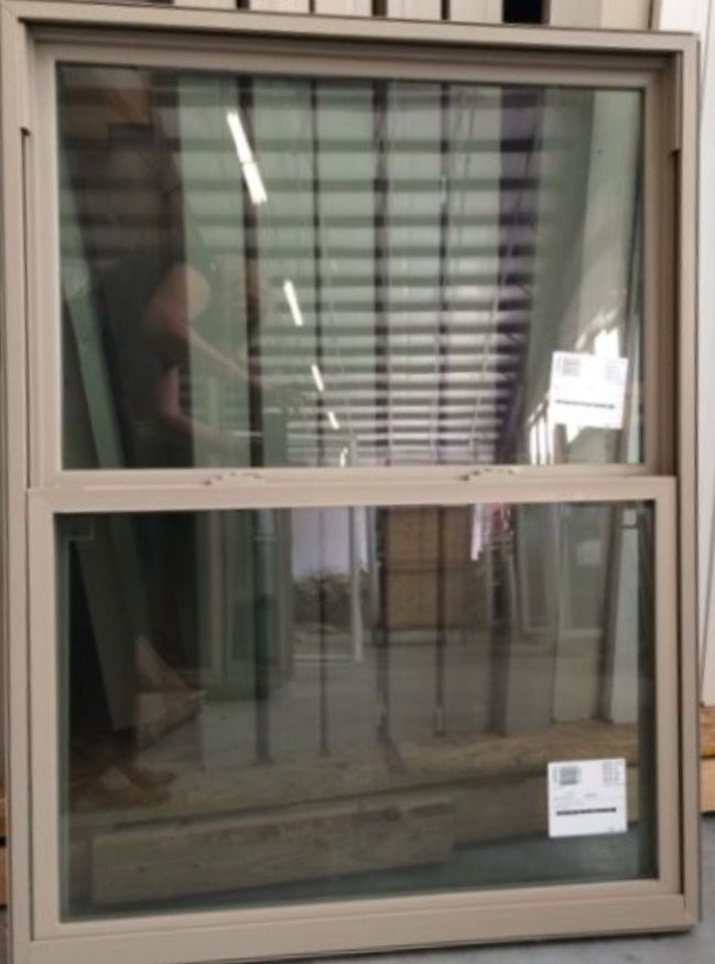 a man is looking out the window in front of his house with blinds on it